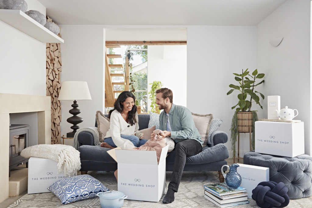 The Wedding Shop couple new home unboxing sofa sitting down