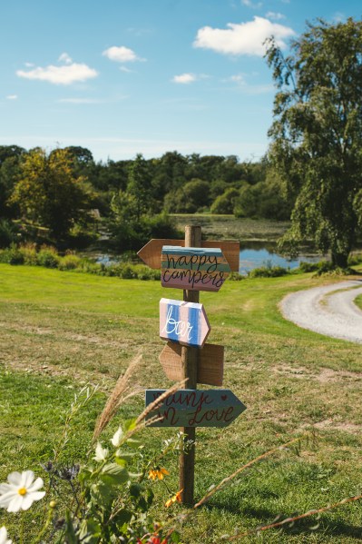 Wedding sign arrows on grass