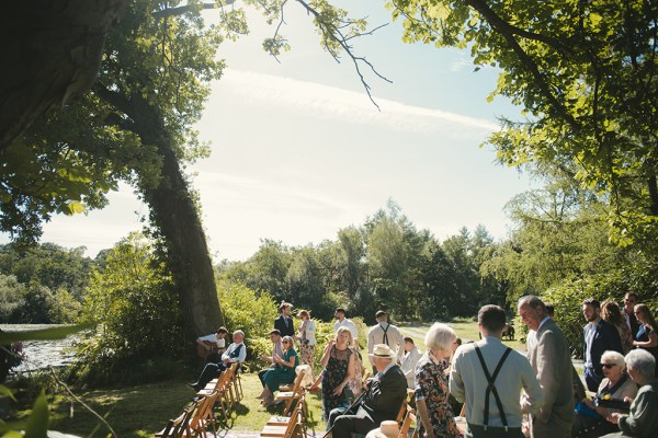 Lake forest/garden park on a sunny day with guests during wedding ceremony