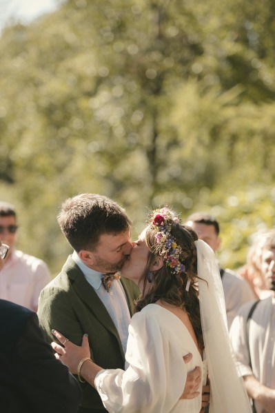 Bride and groom kiss at the alter