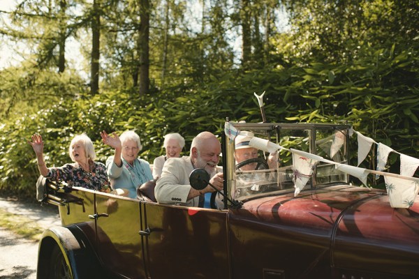 Guests in wedding car driving