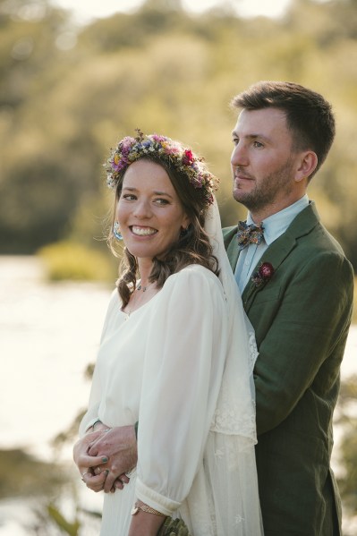 Bride and groom pose in the park/garden