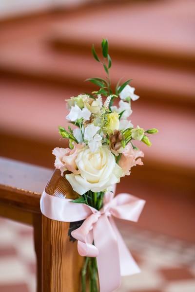 Flower detail on church pew pink ribbon