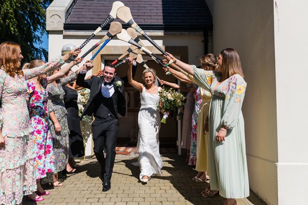 Hurley sticks over bride and groom guests outside church