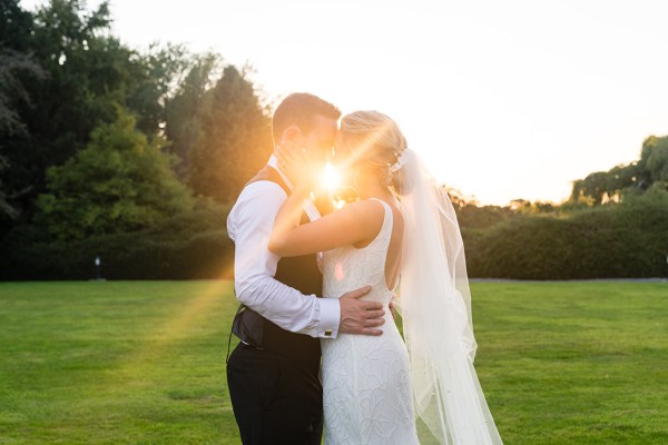 Sunset image vision through couple holding each other bride and groom smiling