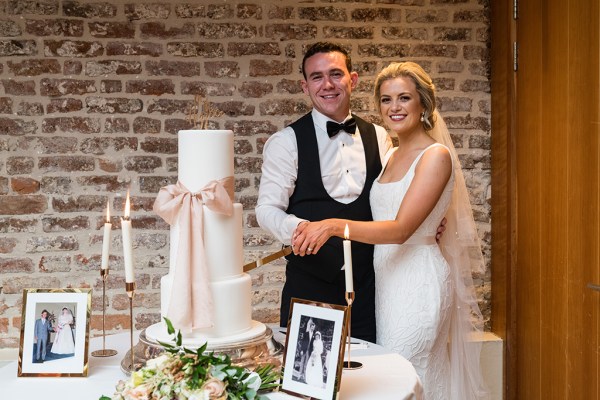 Bride and groom cutting the cake photo frame and candles