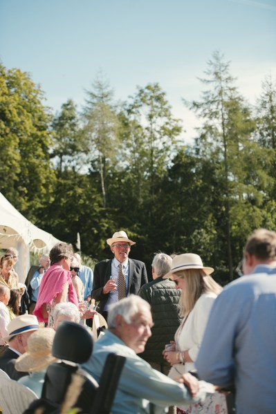 Man with hat on guests atmopshere shot