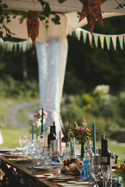 Empty ballroom dining room marquee setting tables flowers decor wine bottles and candles