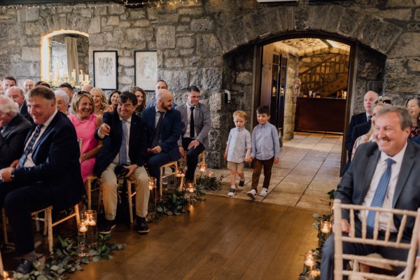 Two little boys walk down the aisle