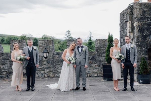 Bridesmaids and groomsmen either side of couple bride and groom