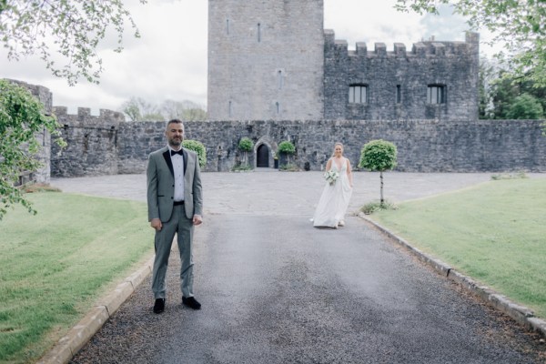 Bride approaches groom on pathway