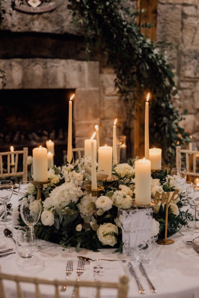 Candles are lit on the table with flowers