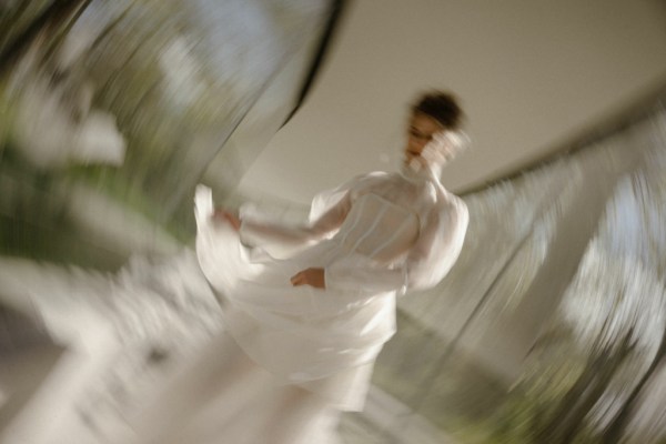 Woman wearing ruffle bridal gown/dress mirror garden in view corridor detail