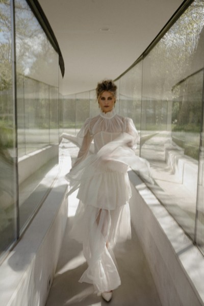 Woman wearing ruffle bridal gown/dress mirror garden in view corridor detail