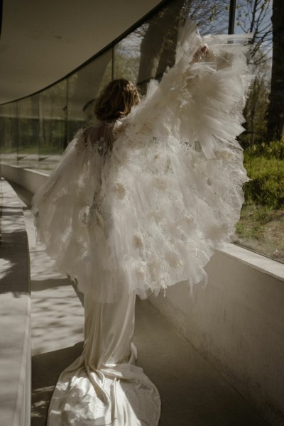 Ruffle feather frill down bride window garden in view lace dress gown detail