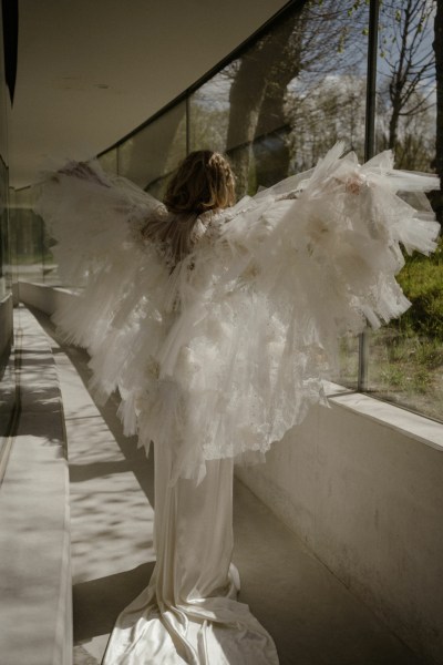 Ruffle feather frill down bride window garden in view lace dress gown detail