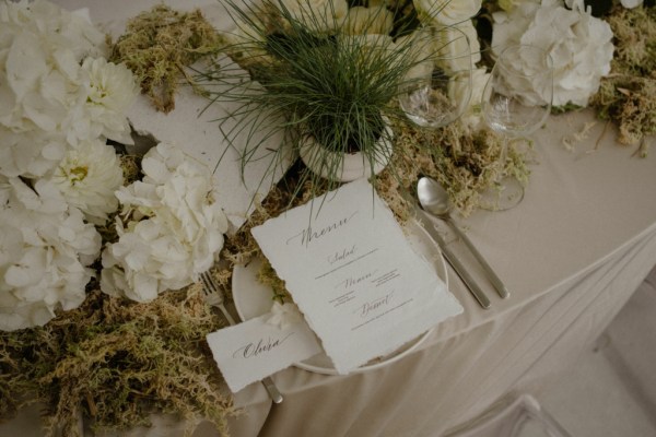 White roses flowers garden in background RSVP letters on table