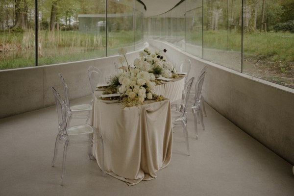 Silky table cloth candles white roses window reflection chairs