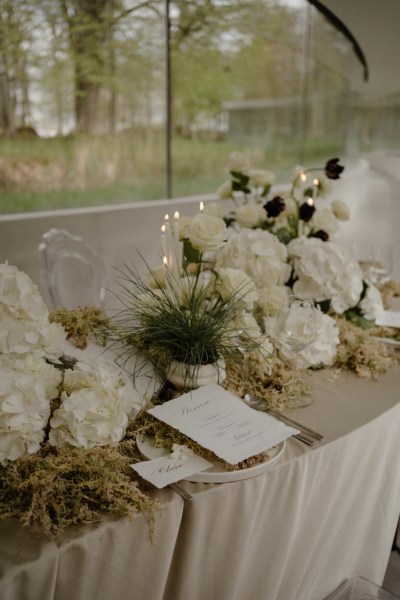 White roses flowers garden in background candles lighting reflection window