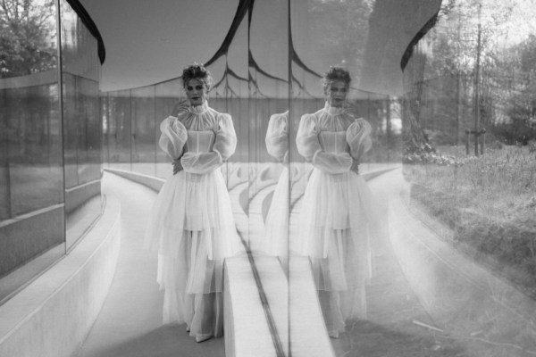 Black and white reflection frilly frilled neck detail bridal gown dress bride full length window shot