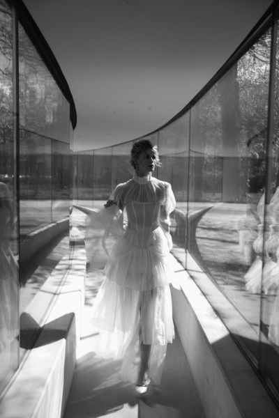 Black and white model frilly frilled neck bridal gown/dress walking along corridor