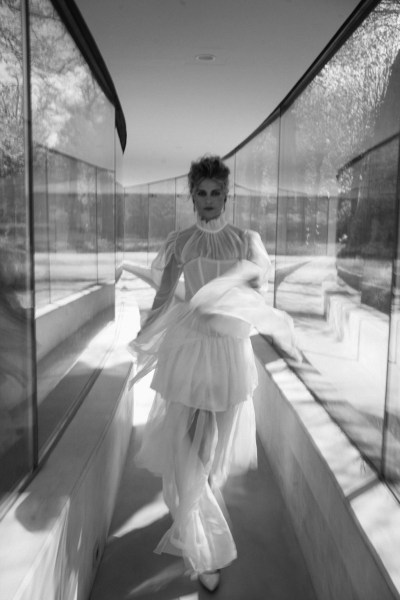 Black and white model frilly frilled neck bridal gown/dress walking along corridor