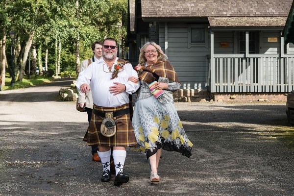 Groom and mother walk towards venue