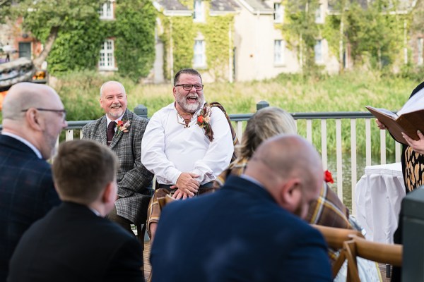 Grooms laugh during wedding ceremony