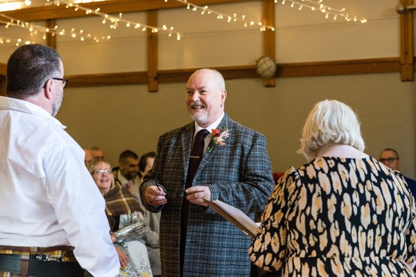 Groom gives speech in dining room ballroom setting