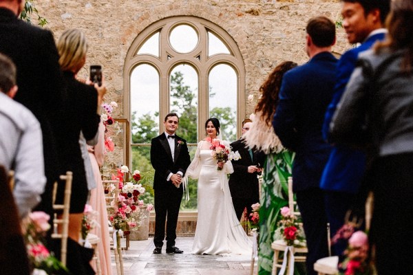 Bride and groom standing at alter together in front of guests