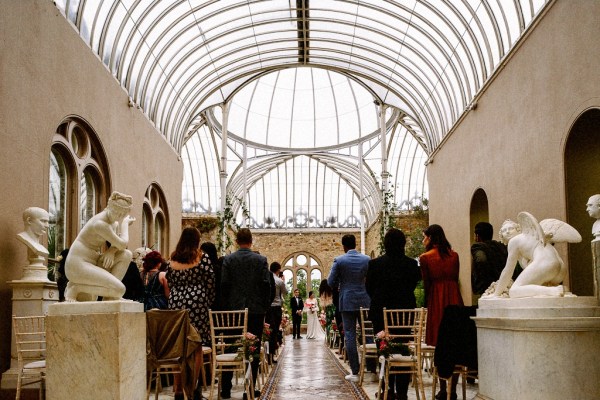 Interior ceremonial room with guests bride and groom