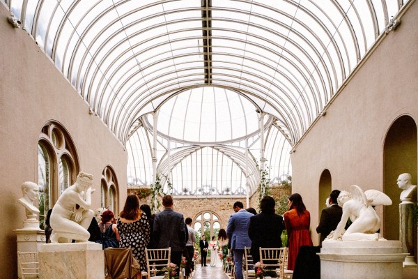 Interior ceremonial room with guests bride and groom