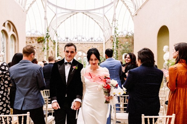 Bride and groom walk out of ceremony smiling