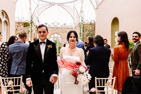 Bride and groom walk out of ceremony smiling