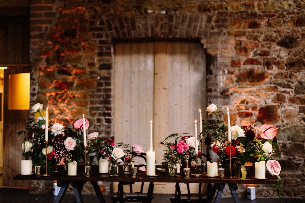 Interior wedding venue table flowers setting barn candles