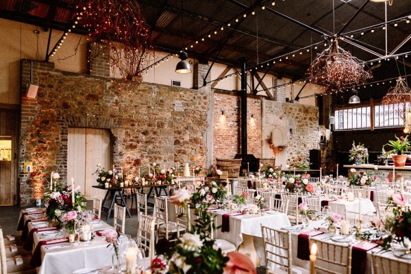 Interior wedding venue table flowers setting barn candles