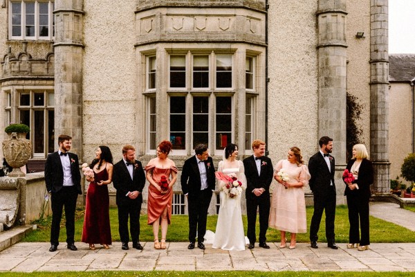 Bride groom bridesmaids groomsmen family pose for a picture