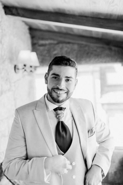 Groom getting ready smiling black and white