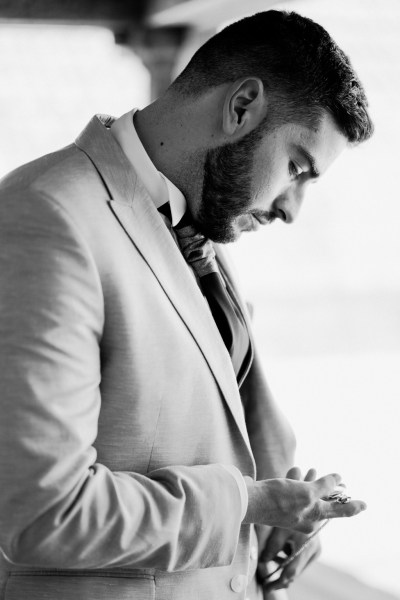 Black and white groom getting ready