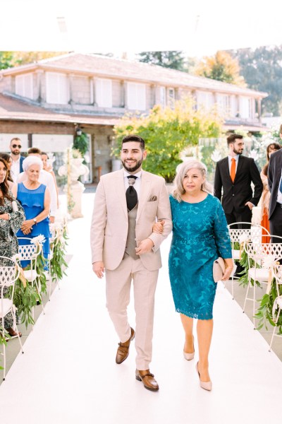 Groom and mother walk down the aisle