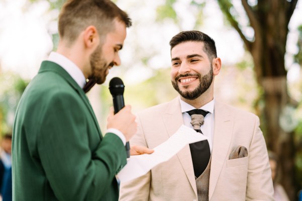 Groom reads vows aloud to groom