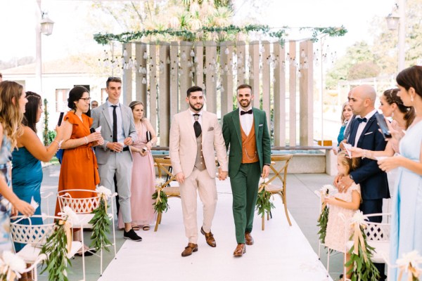 Grooms walk down the aisle after ceremony