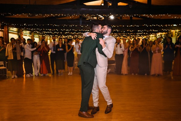 Grooms dance on dancefloor together