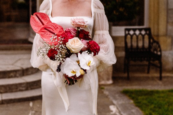 Close up of brides bouquet flowers roses red and pink