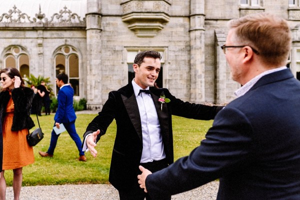 Groom hugs father