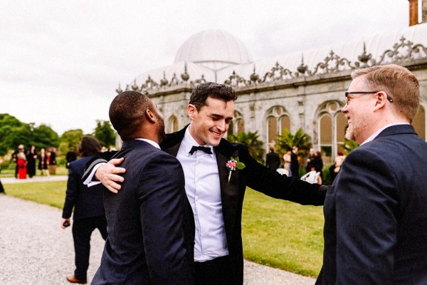 Groom hugs friend groomsmen