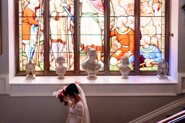 Tinted windows as bride walks down the staircase