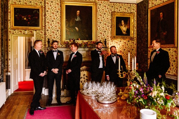 Groom groomsmen in stately room interior