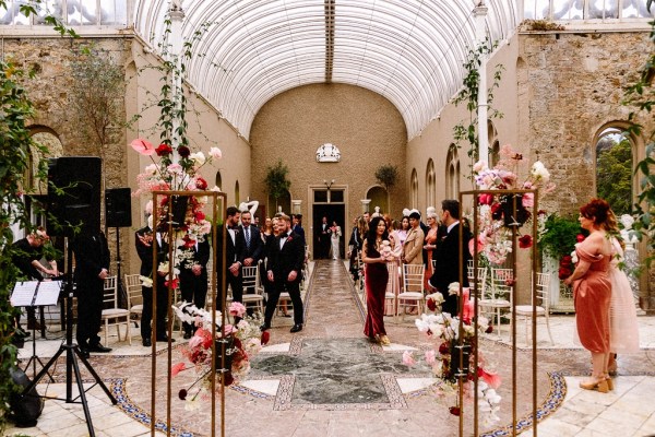 Bride walks up with aisle guests wait