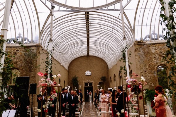 Bride walks up with aisle guests wait